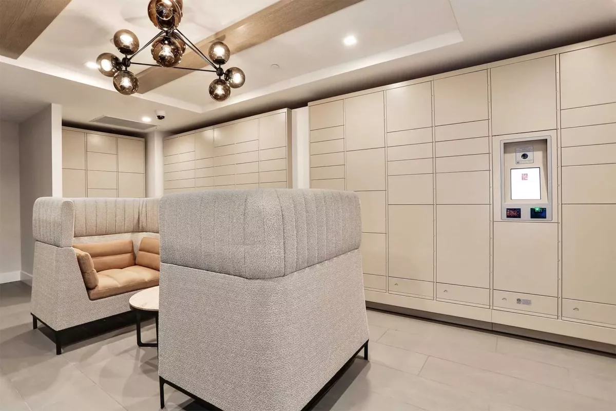 Private lounge nook with upholstered seating, wall lighting, and neutral finishes.