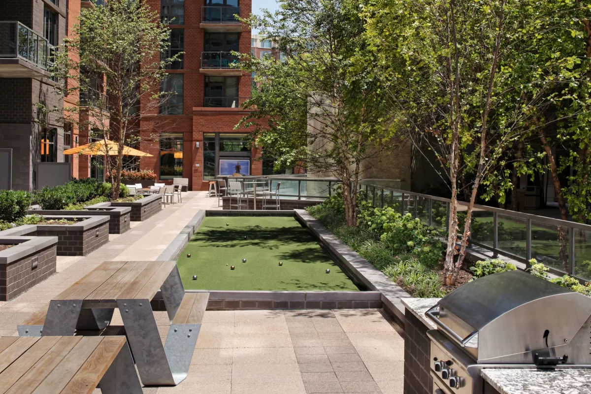 Outdoor bar and grill area with high‑top seating and built‑in counters.