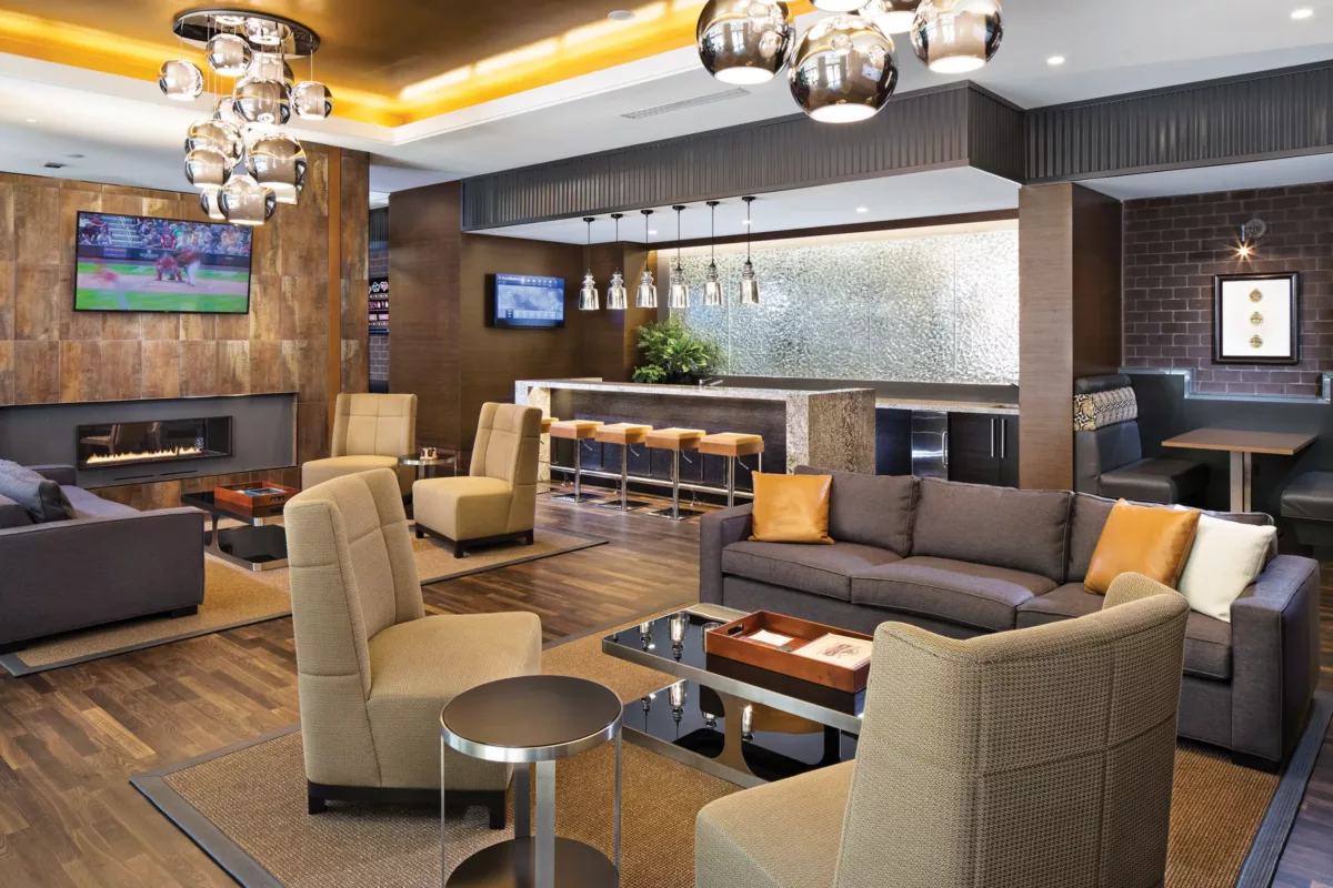 Game lounge with billiards table, seating areas, and warm wood finishes.