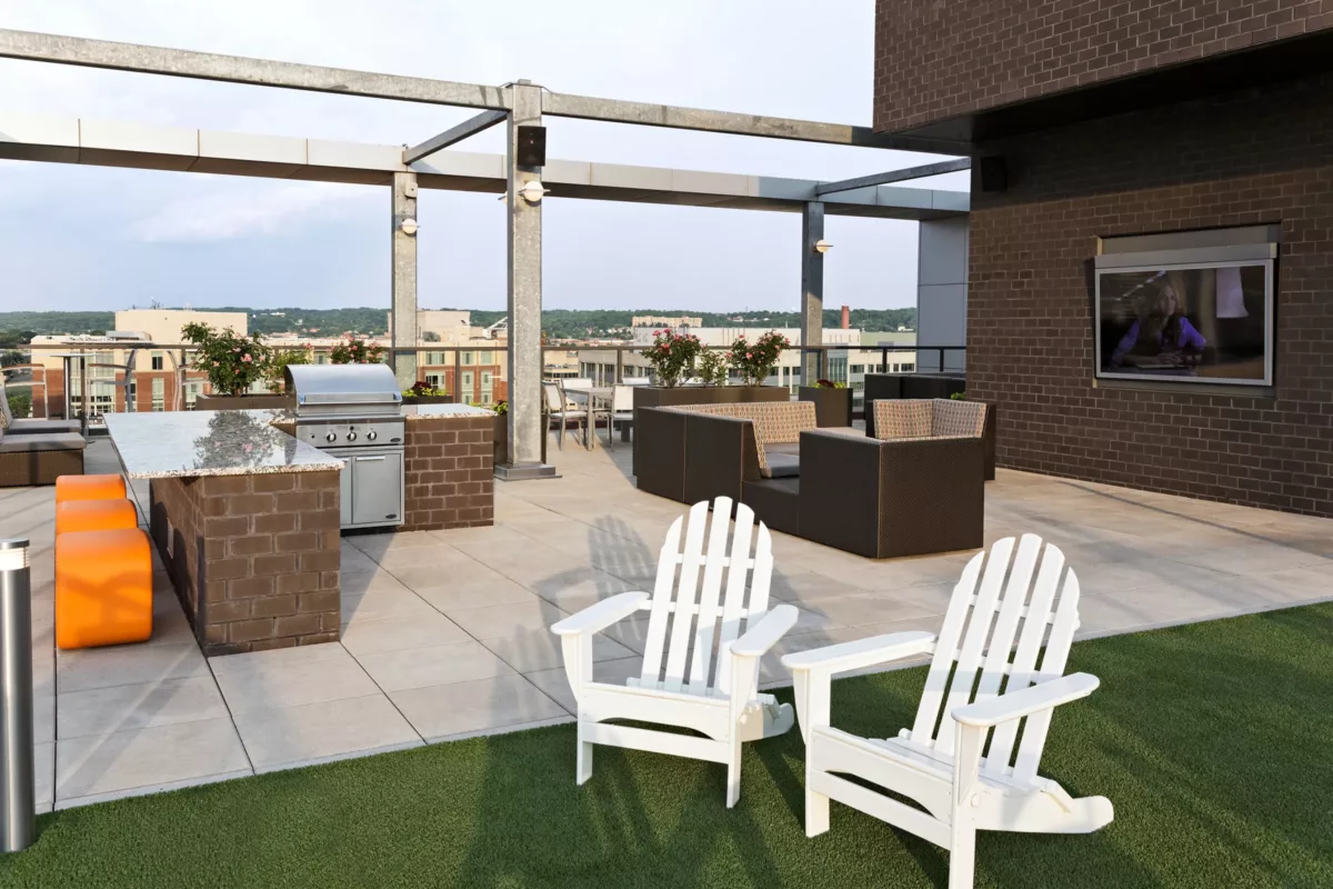 Rooftop terrace with pergola, outdoor seating, fire tables, and city skyline views.