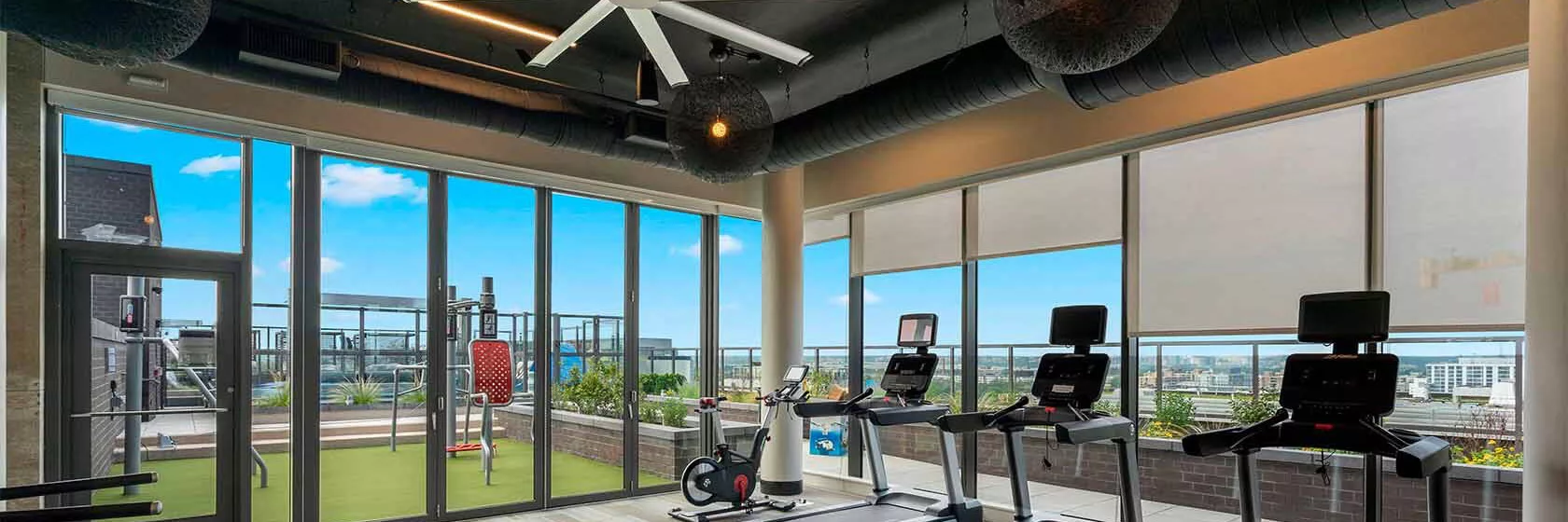 Rooftop Fitness Center featuring treadmills and free weights