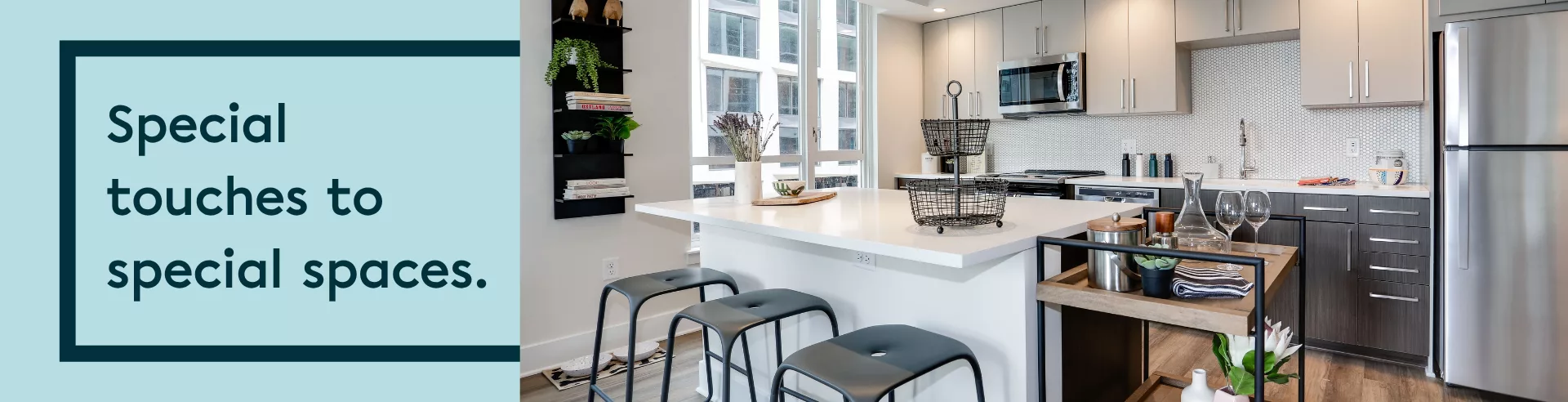Text "Special touches to special spaces." on a light blue background to the left of a photo of a kitchen with beige cabinets, a stainless steel refrigerator, and island with bar stools.